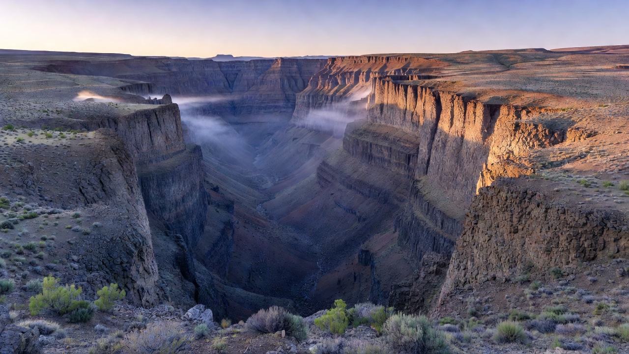 Vast glaciated notch of Kiger Gorge carved into high desert basalt layers at dawn